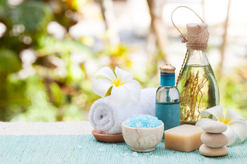 Obraz na płótnie Canvas Spa and wellness massage setting Still life with essential oil, salt and stones Outdoor background Copy space