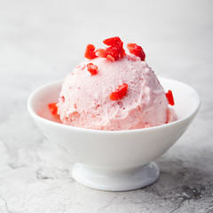 Strawberry sundae ice cream in bowl White stone background Copy space