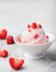 Strawberry sundae ice cream in bowl White stone background Copy space
