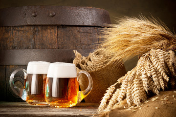 two beer glasses with wheat and barley
