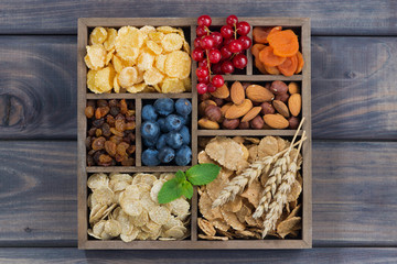 breakfast cereal, dried fruit, berries and nuts in a wooden box
