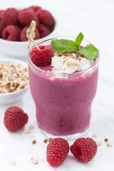 Fresh raspberry smoothie with nuts, closeup