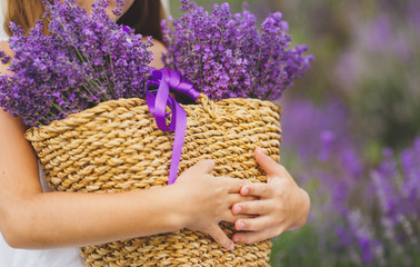 Girl with a basket of flowers lilac lavender