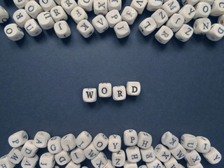 Word Word of small white cubes on a dark background