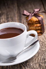 Hot chocolate with homemade oat cookies in satin ribbon.