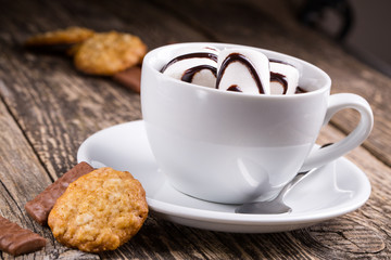 Cup of hot chocolate with marshmallow and candies
