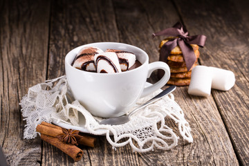 Cup of hot chocolate with marshmallow and oat cookies.
