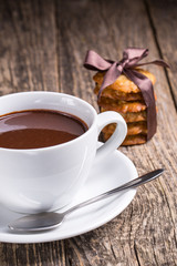Hot chocolate with homemade oat cookies in satin ribbon.