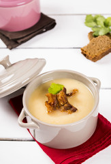 Pea cream soup with bacon crisps in pots 