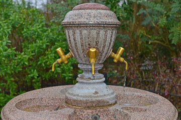 Water fountain in a landscaped alcove in a public park.