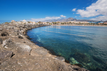 Fototapeta na wymiar Las Americas coastline in Adeje, Tenerife, Spain. Las Americas is one of the most popular and touristic resorts, in Tenerife South area.