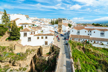 Fototapeta na wymiar White spanish buildings built on the cliffs edge at Ronda. Andalusia. Spain