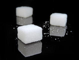 Sugar cubes on black background. Low key close-up.