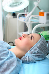 Obraz premium Cosmetologist making permanent makeup on woman's face