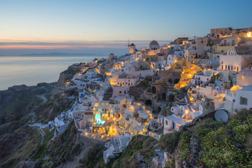 Evening scene in Santorini island with the night light of Oia village