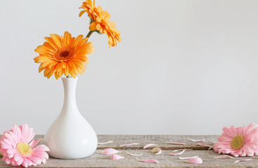 Gerbera in vase on old wooden table