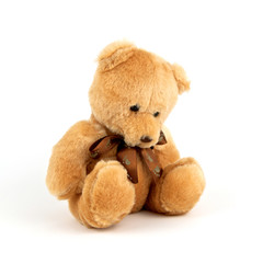 Sad lonely teddy bear isolated on white background. Unhappy and alone doll. Close up.