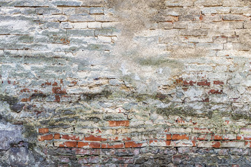 Old plaster on brick wall