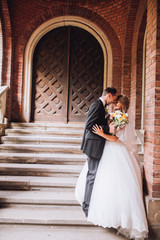 two couple after wedding in tne park near the castle