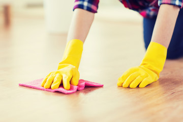 close up of woman with rag cleaning floor at home