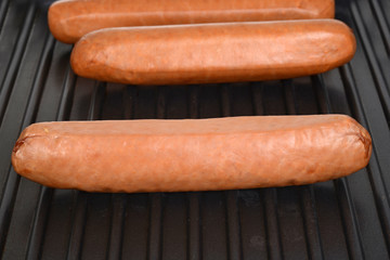 macro uncooked sausages on grill