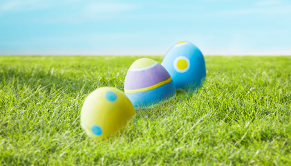 close up of colored easter eggs on grass