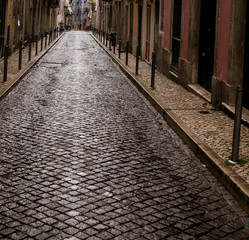 Fototapeta premium wet cobblestone street lisbon