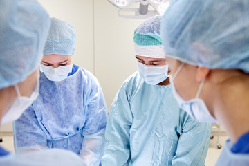 group of surgeons in operating room at hospital
