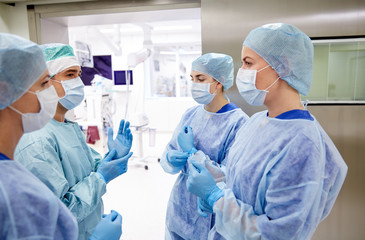 group of surgeons in operating room at hospital