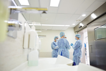group of surgeons in operating room at hospital