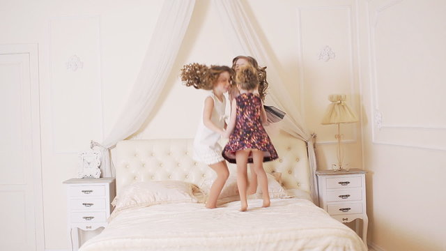 little kids jumping on the bed