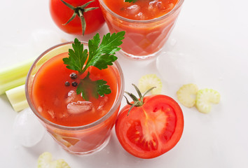 tomato juice with celery on white background