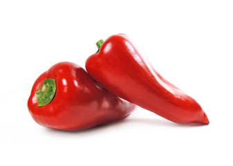 Two red bell peppers, isolated on white background