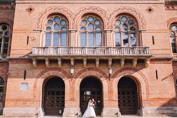 Young woman with tattoo holding a bouquet and poses