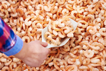 Consumer buys shrimp in supermarket
