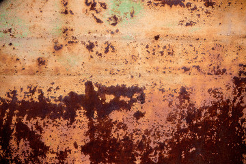 Old rusty metal wall with yellow peeling paint