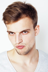 Obraz premium young handsome man on white background gesturing, pointing, posing emotional, cute guy sexy