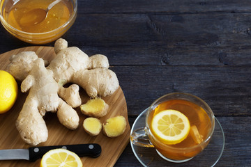 Cup of Ginger tea with lemon and honey on dark blue background