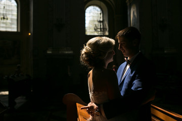 bride and groom illuminated by light