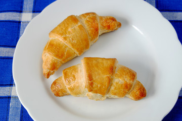 Homemade croissant on a white plate
