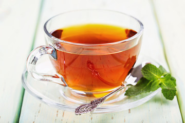 Tea in a transparent cup with mint leaves