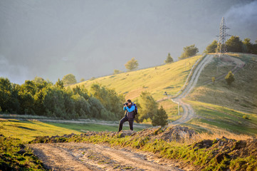 young boy photographing mountains