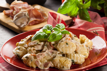 Potato gnocchi, Italian potato dumplings with cheese sauce, ham