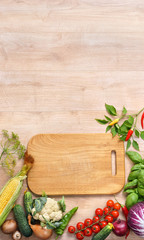 Healthy food background and Copy space / studio photography of wooden board surrounded by fresh vegetables on wooden table