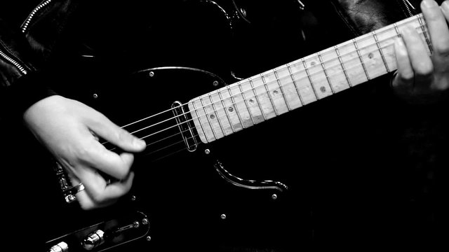 Musician playing electric guitar. Black and white.
