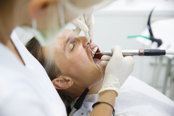 Patient getting her gum pocket depth measured