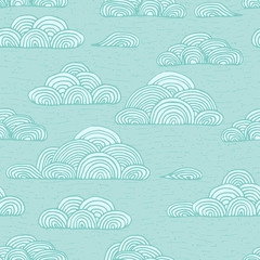 Abstract vector seamless gentle pattern with clouds. Colorful stylized hand drawn cloudy sky texture on light background