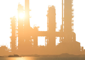 Oil refinery isolated on white background with sea sunset, silhouette of oil refinery plant.