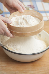 Women's hands prepairing flour before baking pie