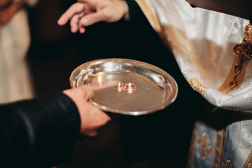 Newlyweds dress wedding ring in the church